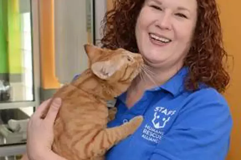 lisa holding a happy orange cat