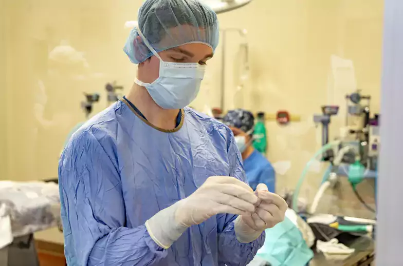 Person in scrubs with the surgery suite in the background